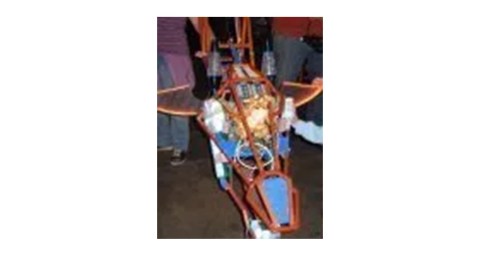 The frame of a small airplane or other flying machine on exhibit.
