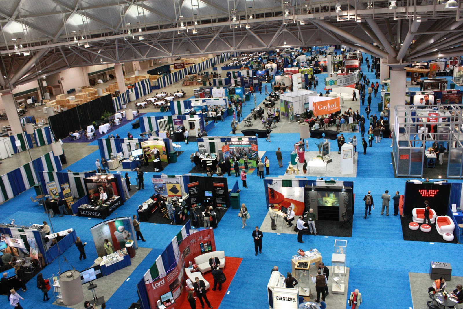 Image: an aerial shot of the MuseumExpo showfloor with many exhibitor booths arranged in a grid
