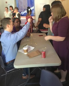 Alliance staff explore the marshmallow challenge in a team building exercise at the National Building Museum.