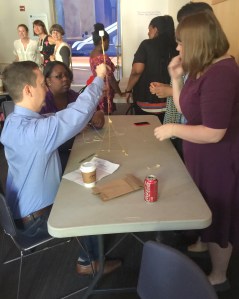 Alliance staff explore the marshmallow challenge in a team building exercise at the National Building Museum.