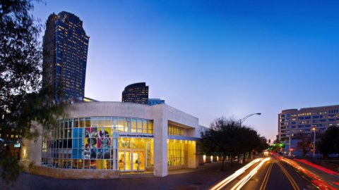 Image: The Levine Museum of the New South at sunset; car lights streaking