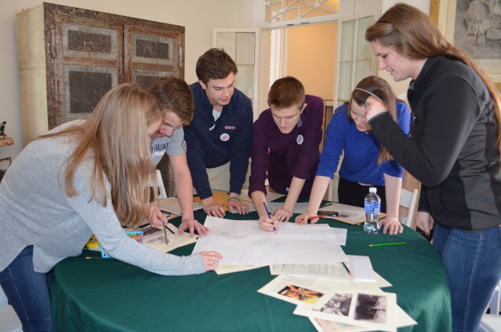 A group of teens around a table playing an Advocacy Game