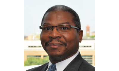 Image of smiling Arthur Afflect in suit