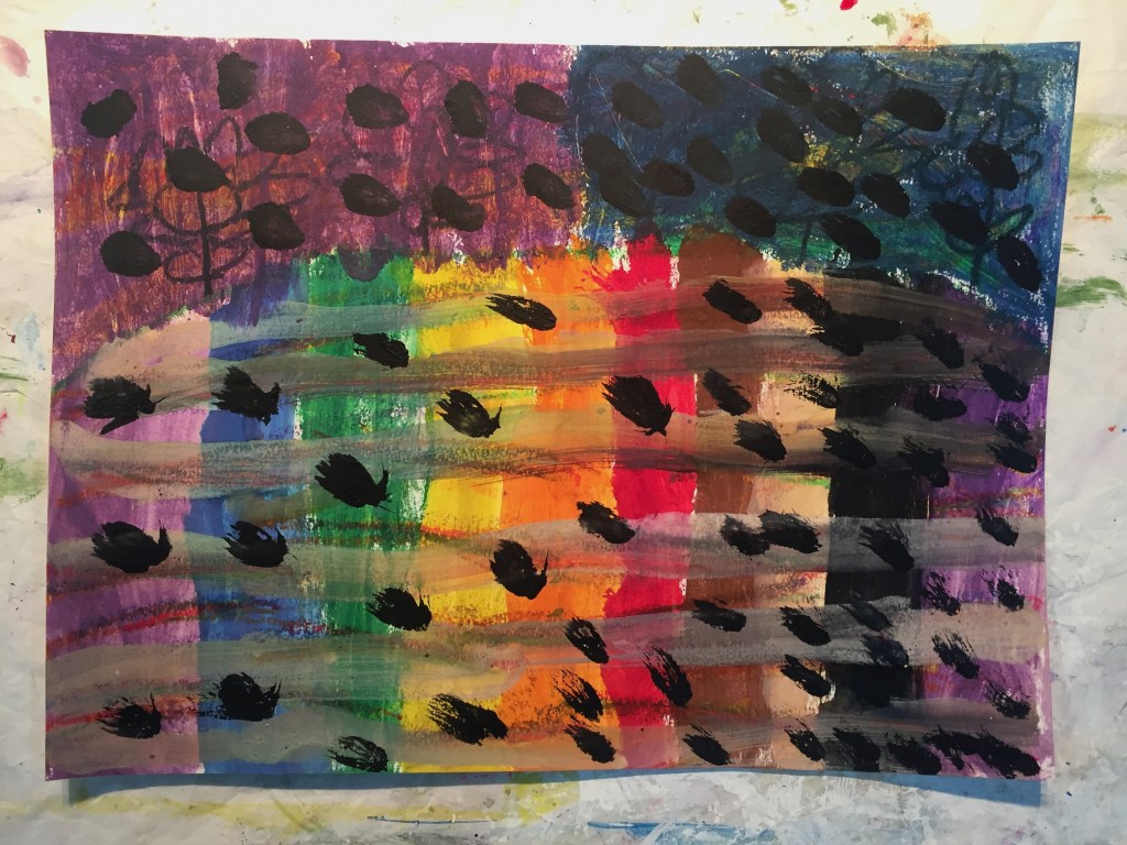 Rainbow colored painting with black polka dots throughout.