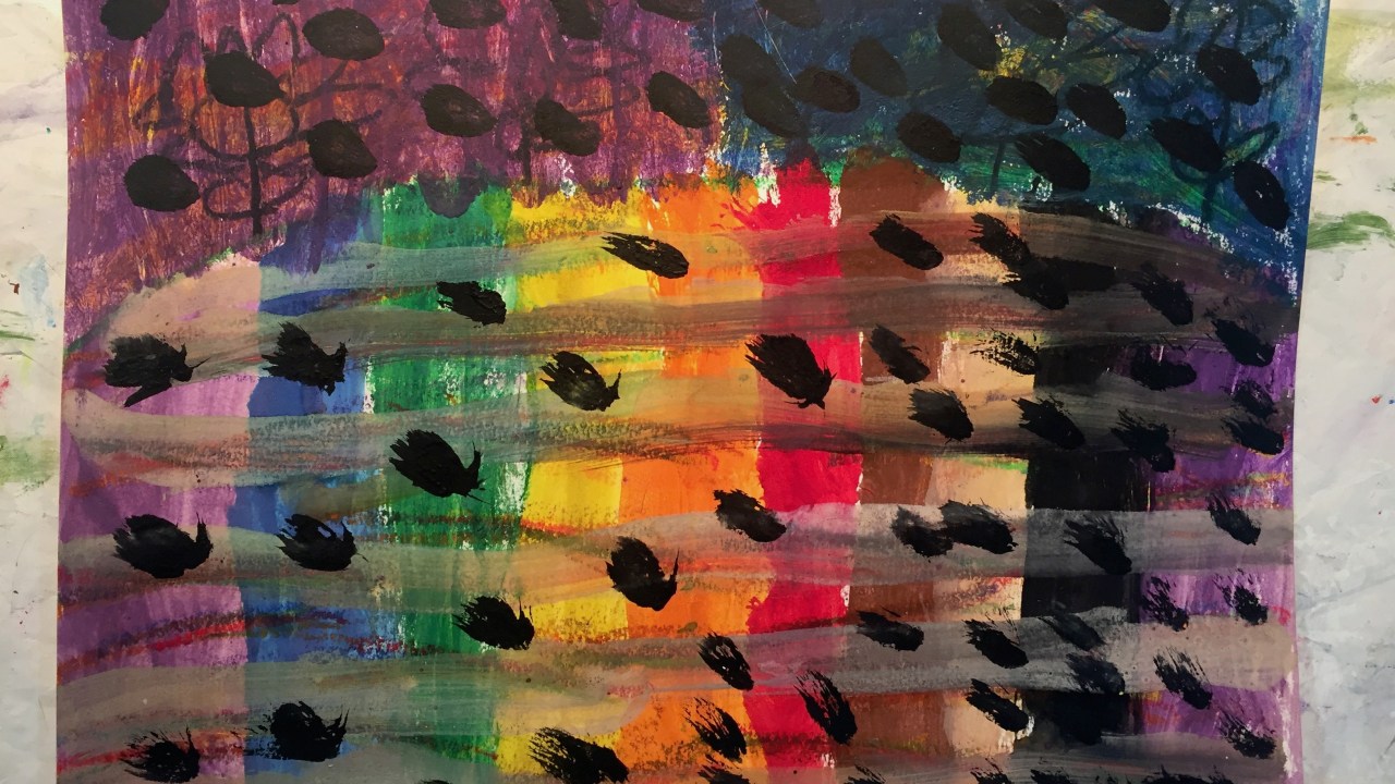 Rainbow colored painting with black polka dots throughout.