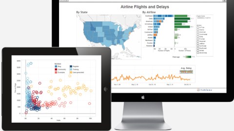 A computer screen and a tablet next to each other with data visualization tools displayed.