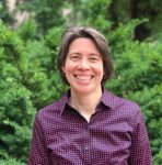 Image of a woman with short black hair in a purple shirt.