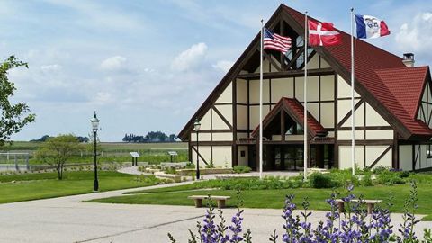 Image of A-frame building with flags in front.