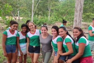 A group of 7 women crowd together for the picture