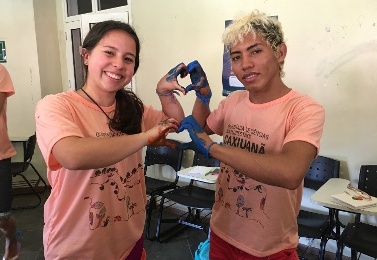 2 individuals hold up their hands together to make hearts
