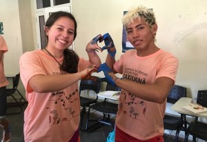 2 individuals hold up their hands together to make hearts