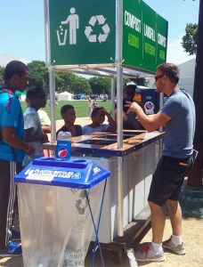 A Smithsonian volunteer helps explain where the waste goes to a small group of young people