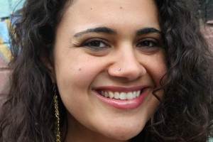 Woman is smiling with her head slightly tilted