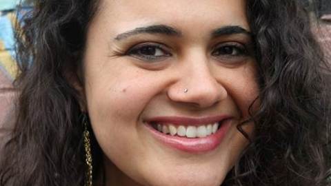 Woman is smiling with her head slightly tilted