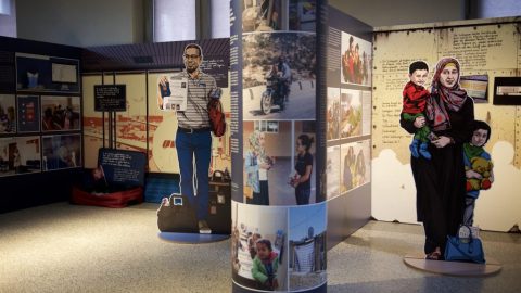 Image of an exhibit with two figures shown standing with children