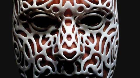Image of a person's face wearing a 3-D printed mask in white