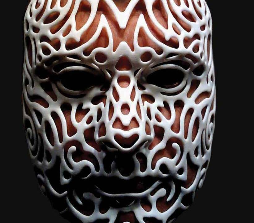 Image of a person's face wearing a 3-D printed mask in white