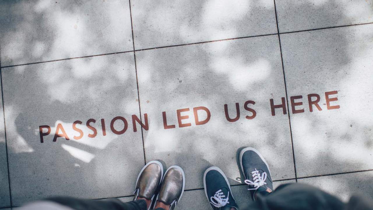 Image looking down at the concrete that says Passion Led Us Here