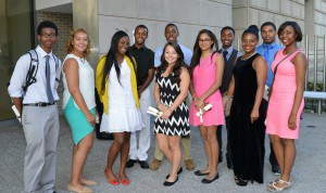 A group of teens stand and pose for the camera