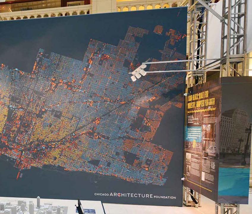 A large board with a map in a room with various other types of data analysis equipment