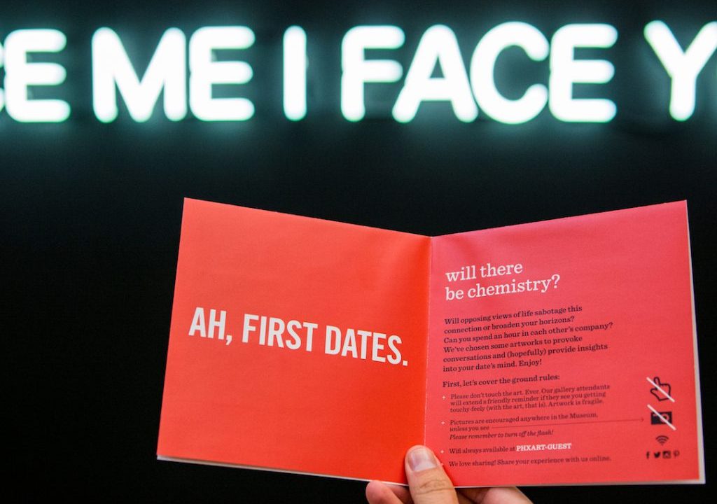 Mi I Face Ah, First Dates written on a card being held by someone