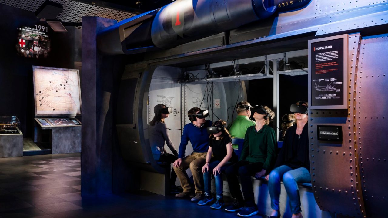 Group of students sitting in a simulator with VR headsets on their heads
