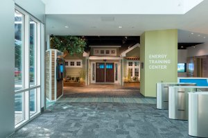 Image of the interior of an exhibiiton space showing what appears to be a house inside the exhibition.
