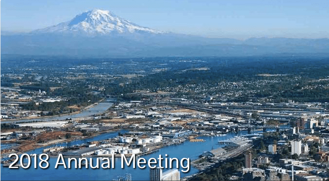 Image: skyline of Tacoma, Washington with mountain in the background and river in the foreground