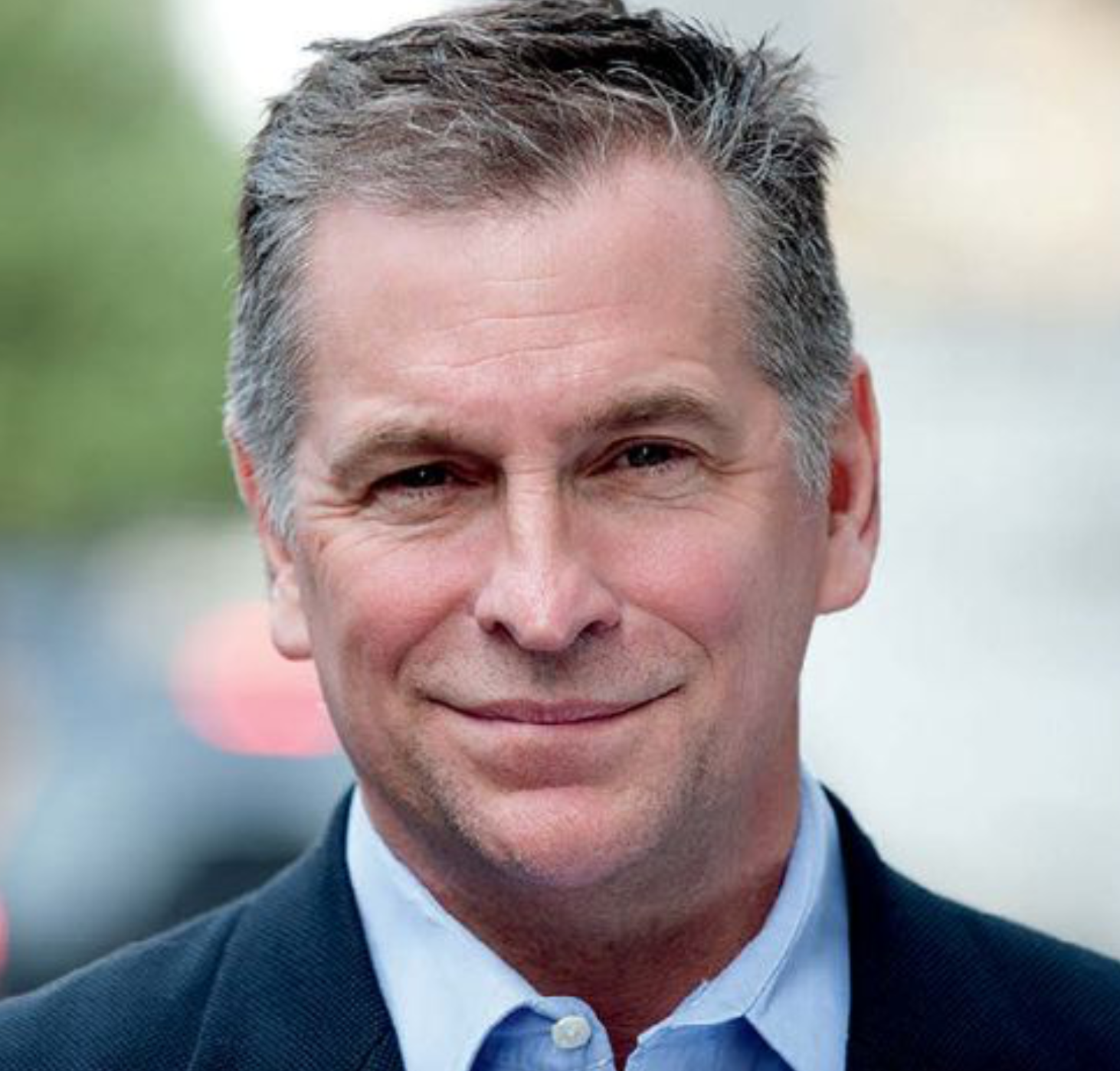 Headshot of Kevin Jennings wearing a dark suit