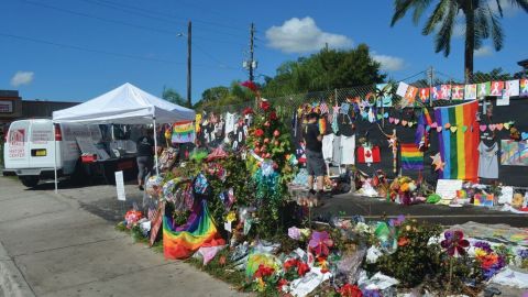 A colorful memorial of flowers and flags lines the sidewalk outside Pulse Nightclub.