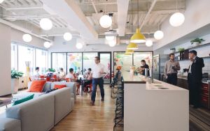 View of an office with a coffee bar and couch seating area. 