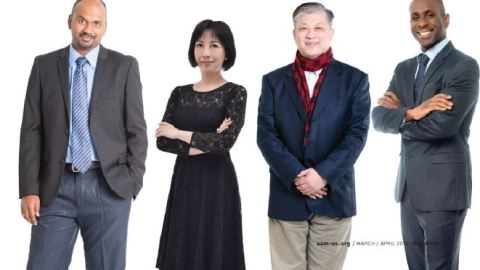 Four people stand in a line facing the camera.