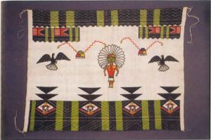 Native textile with a humanoid figure and birds. 