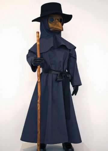 A mannequin dressed from head to toe in a long trench coat with a collared hood, plaque mask and black large rimmed hat holding a wooden stick. 