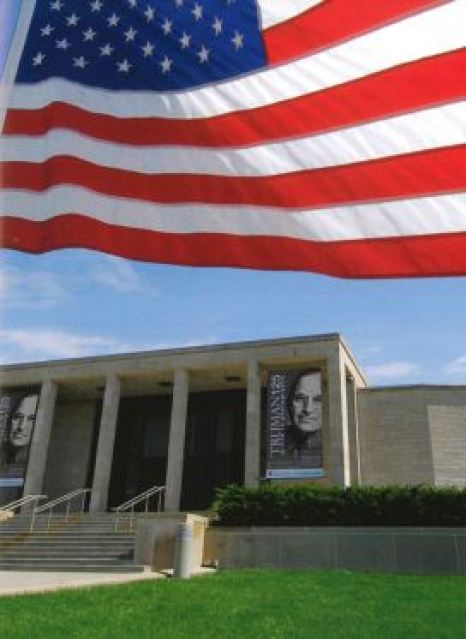 Image of the exterior of the museum with the American flag flying at the top of the image. 