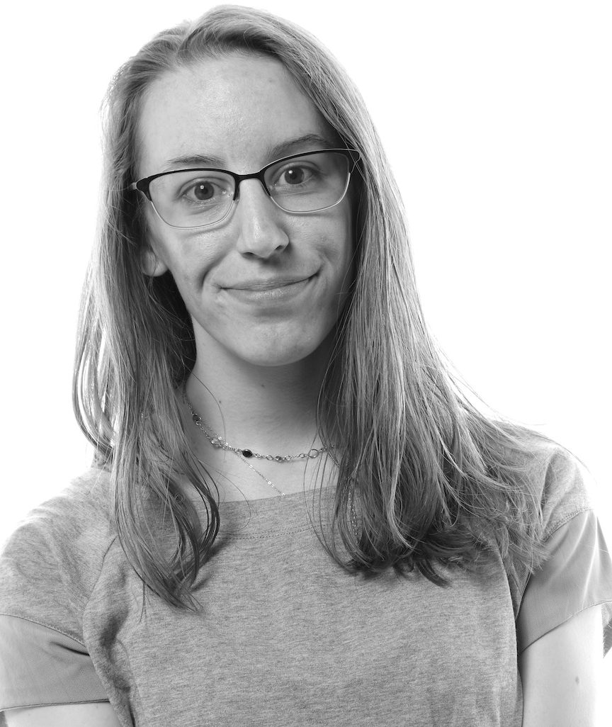 Black and white headshot of a woman half smiling with shoulder length blond hair
