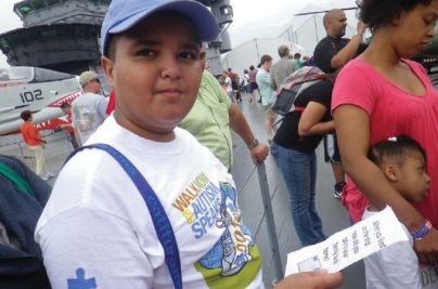 Participants in an Intrepid Sea, Air & Space Museum Access Family program use question prompts to interview a former crew member.