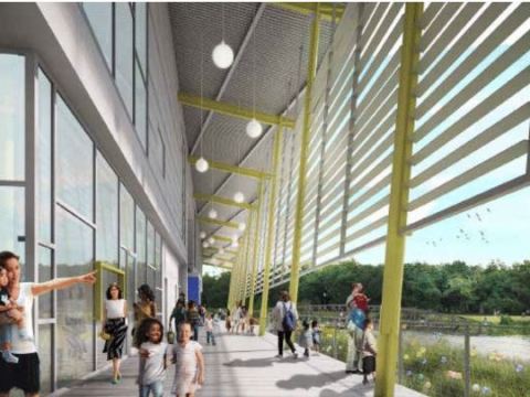 View of the porch of a green building with people throughout.
