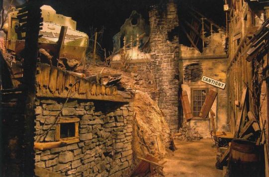 A simulated bombed-out World War I French village with ravaged stone buildings. 