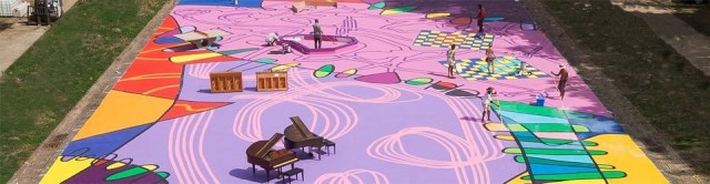 Image of a large outdoor area pinted with various shapes in pinks and purples with pianos and benches all over.