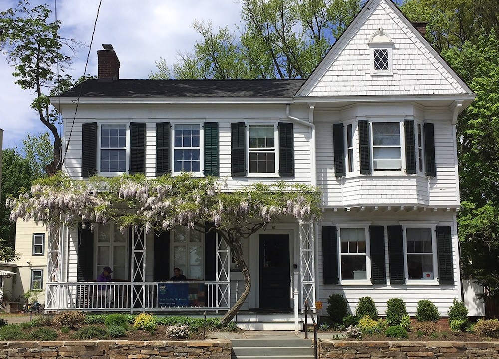 Exterior image of a white house with a front porch.