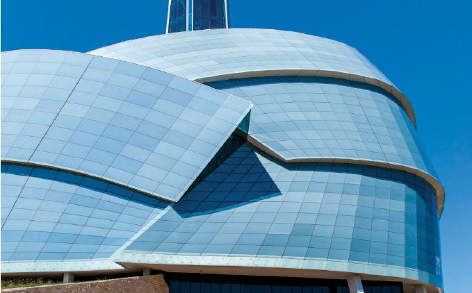 Exterior shot of the museum with overlapping glass structures in the shape of a helmet.