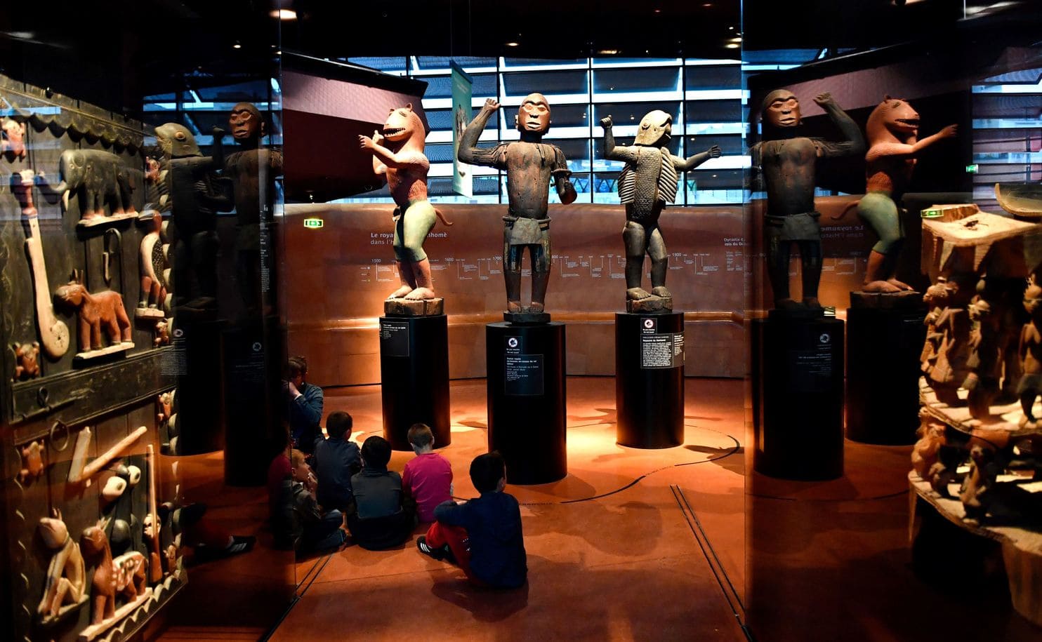 statues and other artifacts from the Kingdom of Dahomey on display at the Musée du Quai Branly in Paris
