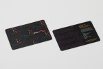 Two black rectangular cards sit at an angle on a grey background. 