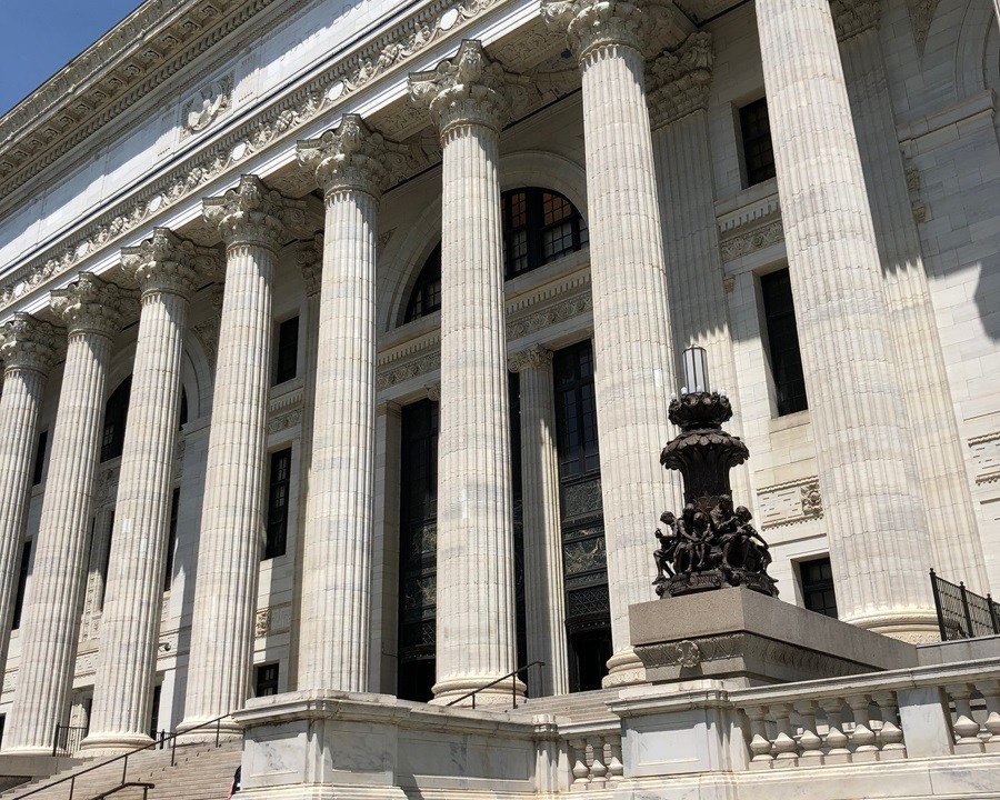 Angled image of a classic style facade with a columned entrance.