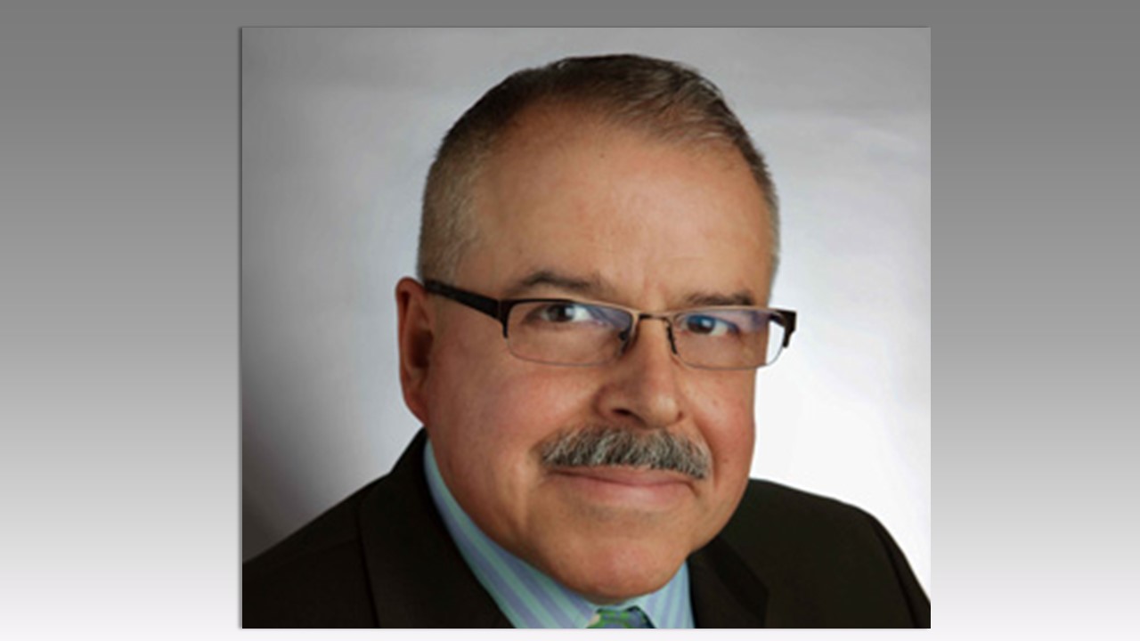 Headshot of Eduardo Diaz with short dark hair and dark wire rimmed glasses.