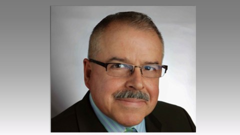 Headshot of Eduardo Diaz with short dark hair and dark wire rimmed glasses.