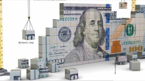 A $100 dollar bill stands at an angle made up of blocks with construction equipment placing the blocks on either end.