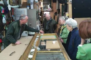 Frame conservator Bill Adair describes his work to Dumbarton House staff and volunteers at his studio. At Dumbarton House, acquisition and conservation of collections items, like this tri-part over-mantel looking glass, are funded through a mix of contributed and earned income.