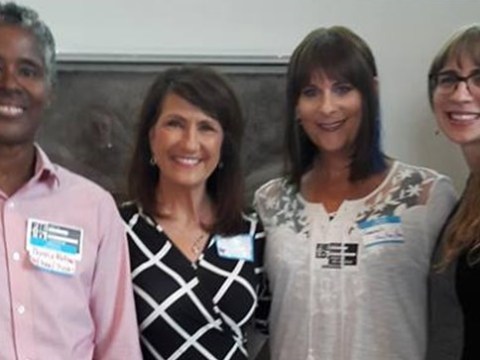 Speakers at a CAMP meeting about museum inclusivity issues around gender identity are shown posing together.